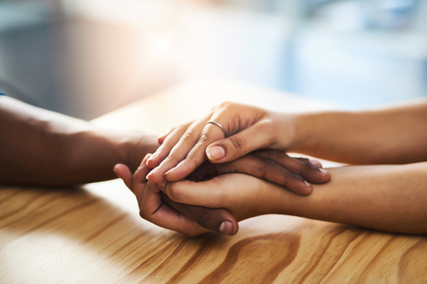 hands touching across table